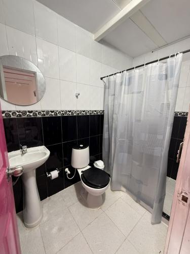 a bathroom with a toilet and a sink and a shower at Mirador Verde By Nala in Circasia