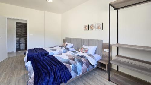 a bedroom with two beds and a mirror at Tabarja Heights in ‘Ayn aş Şughayrah