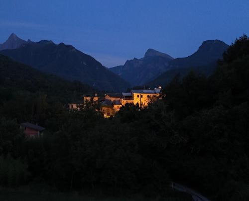 a house in the middle of the mountains at night at Le case di Rosie, Mountain view, Tuscany in Gragnola