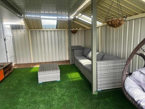 a screened in porch with a couch and grass at 3 bedroom Kids friendly home in Perth