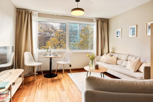 a living room with a couch and a table at Modern Suites, Excellent Location in the heart of Bergen in Bergen