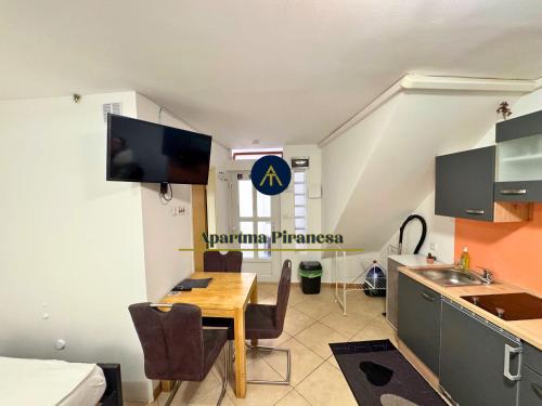 a kitchen and dining room with a table in a room at Apartma Piranesa III in Piran