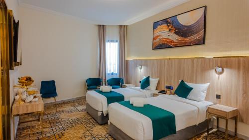 Ένα ή περισσότερα κρεβάτια σε δωμάτιο στο فندق بونسيانا - Poinciana Hotel