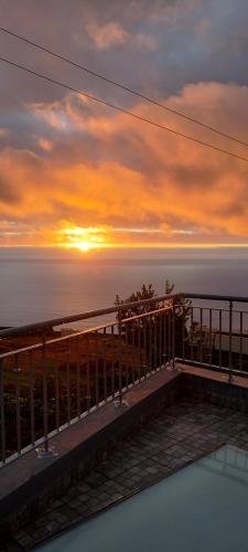 a view of the sunset from the balcony of a house at Beautiful View 1 - Arco da Calheta - Ilha da Madeira in Arco da Calheta