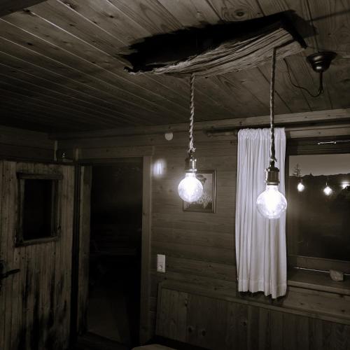 two lights hanging from the ceiling of a room at Alpine Auszeit am Wilden Kaiser in Scheffau am Wilden Kaiser
