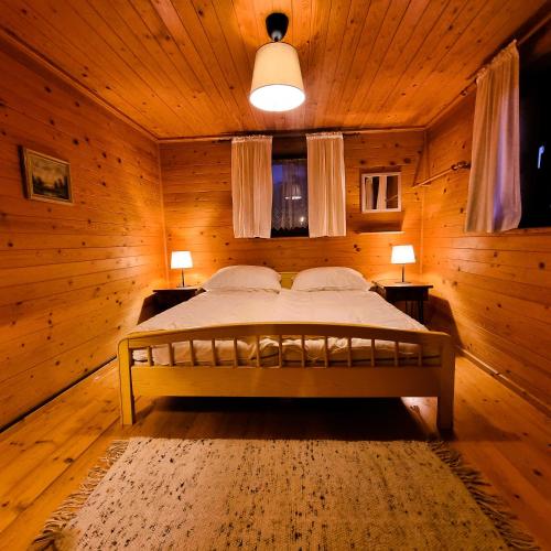 a bedroom with a bed in a wooden room at Alpine Auszeit am Wilden Kaiser in Scheffau am Wilden Kaiser