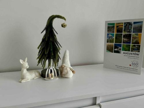 a white counter with a christmas tree and two rabbits at BM Apartament in Augustów