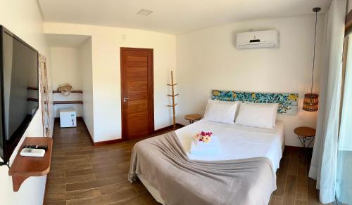 Postel nebo postele na pokoji v ubytování Arraia Suítes Pousada