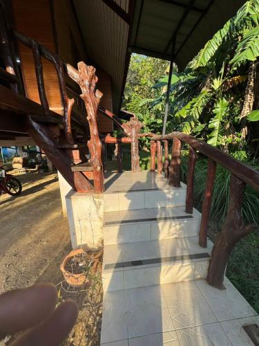 a wooden bench sitting in front of a building at Family house in Ban Laem Sai