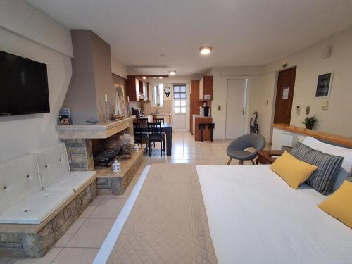 a living room with a bed and a fireplace at Cozy Apartments near the airport in Artemida