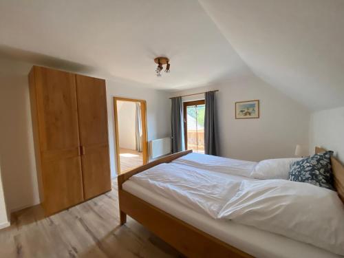 a bedroom with a large bed and a wooden cabinet at Ferienhaus Haas in Laufen