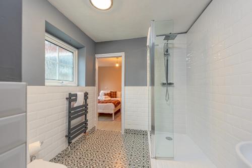 a bathroom with a shower and a sink at Charming Cottage in the Heart of Newport - Pass the Keys in Newport