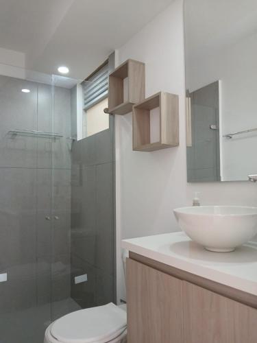 a bathroom with a toilet and a sink and a shower at Five Homes Ricaurte in Ricaurte
