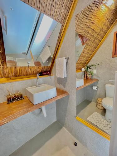 a bathroom with a sink and a mirror at Pousada Villa di Luna in São Miguel do Gostoso