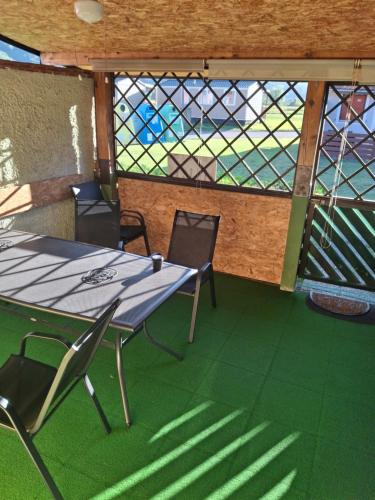 a table and chairs in a room with a window at Aca's & Lidija's Thermal Hideaway Čatež - Tickets included in Brežice