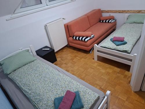 a living room with two beds and a couch at Aca's & Lidija's Thermal Hideaway Čatež - Tickets included in Brežice