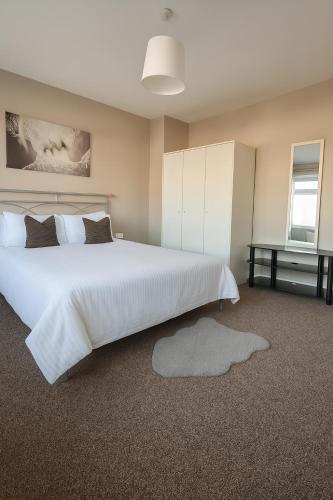 a bedroom with a large white bed and a desk at City Stays Norwich NR3 in NWI