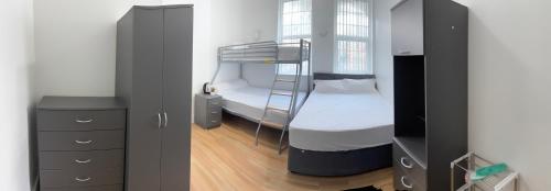 a small bedroom with a bunk bed and a dresser at Wicker guesthouse in Sheffield