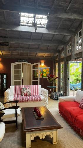 a living room with a couch and a coffee table at Pousada Canto do Camburi in Camburi