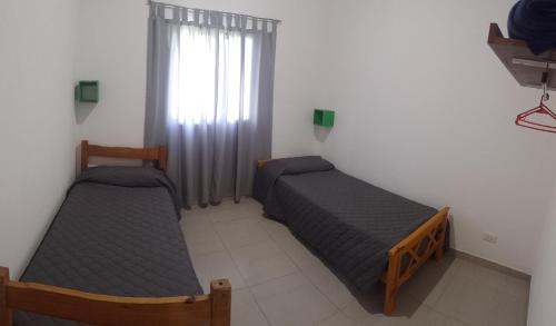 a bedroom with two beds and a window at Sal y Arena in Colonia Chapadmalal