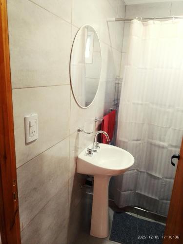 a bathroom with a sink and a mirror at Sal y Arena in Colonia Chapadmalal