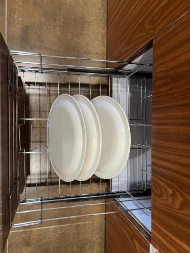 drie borden hangen in een magnetron bij luxury stay in Dehradun