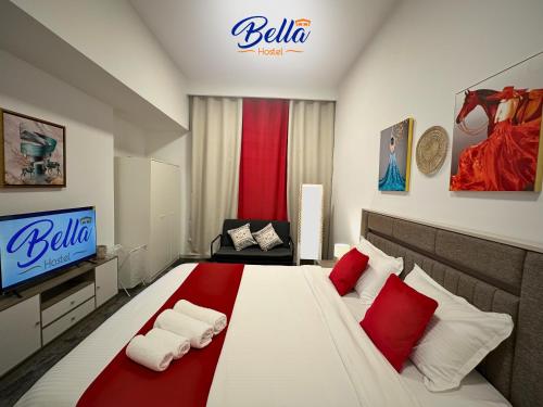 a bedroom with a large bed with red and white pillows at Bella INN - Deluxe Master Room - No Smoking in Dubai
