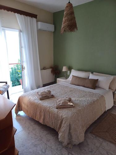 a bedroom with a large bed with two towels on it at Thea Rooftop in Skiathos