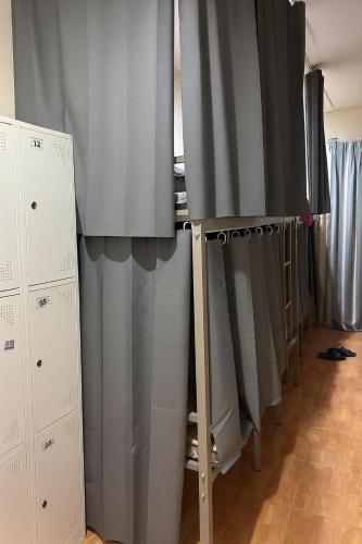 a row of gray curtains in a room at Sundiva Guest House in Patong Beach