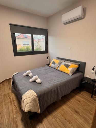 a bedroom with a bed with two towels on it at Maroulla's Modern & Spacious Family Home near the Beach in Limassol