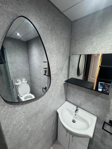 a bathroom with a sink and a mirror at Reads Avenue - Luxury Ground Floor Studio - Next Door to H&A Social Club in Blackpool