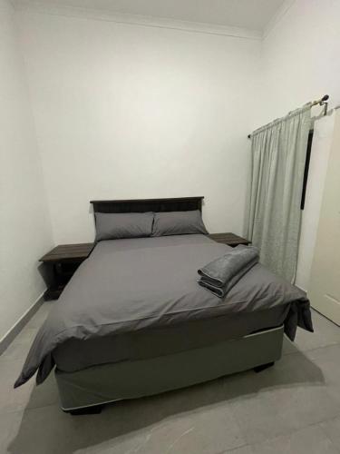 a bed in a white room with a bed sidx sidx sidx at Wings & dreams in Windhoek