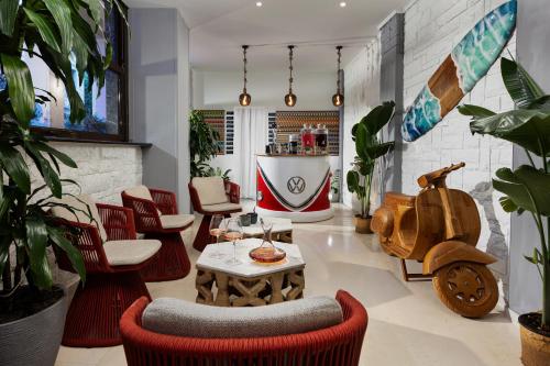 a room with chairs and a table and a scooter at The Square Hotel by X&N in Athens