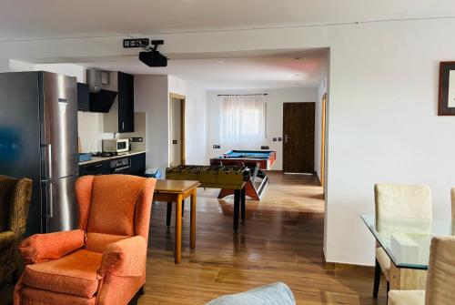 a kitchen and a living room with a pool table at House with ocean and mountain views in Santa Susanna