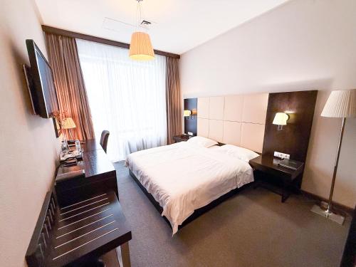 Postel nebo postele na pokoji v ubytování Voyage Hotel