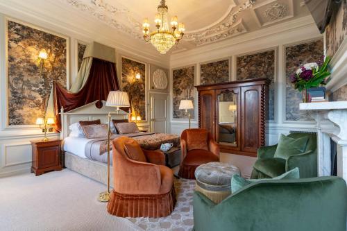 a bedroom with a bed and a chandelier at The Royal Hotel in Bideford