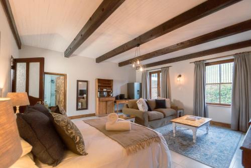 a large living room with a bed and a couch at Mountain and Tides in Kleinmond