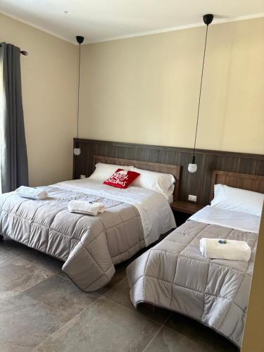 a bedroom with two beds with towels on them at Andrea House in Naples