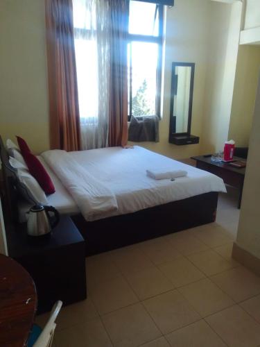 a bedroom with a large bed with a window at A Villa in Shillong
