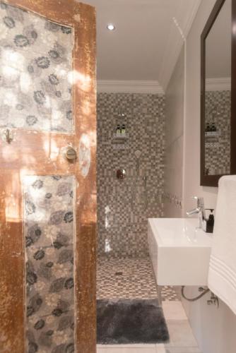 a bathroom with a shower and a sink at Mountain and Tides in Kleinmond
