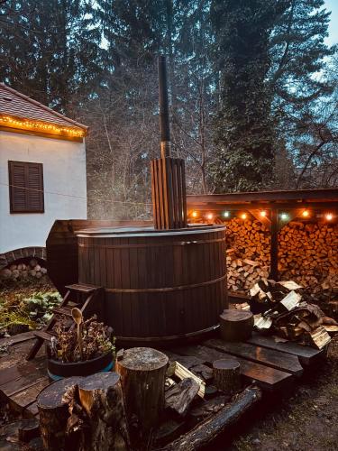 a wooden deck with a hot tub in a yard at Székelykapu vendégház in Mátraszentimre
