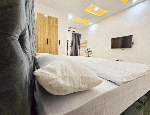a bedroom with a white bed with a pillow at 3-Bedroom fully serviced terrace in Orchid, Lekki Sig4 in Lekki