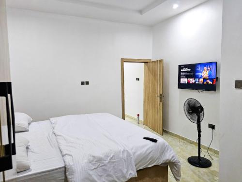 a bedroom with a bed and a flat screen tv at 3-Bedroom fully serviced terrace in Orchid, Lekki Sig4 in Lekki