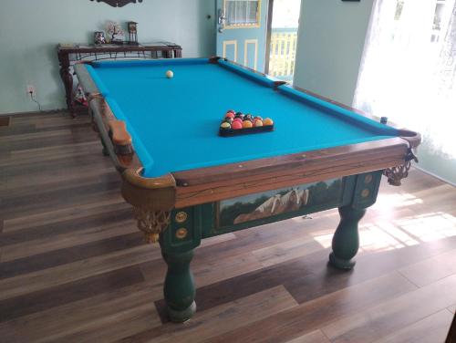 a pool table with a bowl of balls on it at Serenity Now Sunset Beach in Sunset Beach