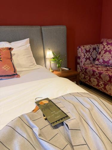 a book sitting on a bed in a room at The Libreville in Abuja