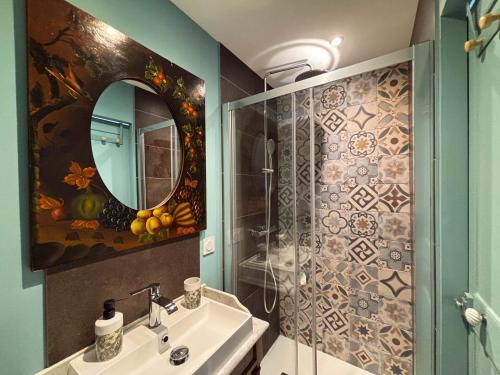 un baño con lavabo y espejo en Les Chambres de MARIE, en Villié-Morgon