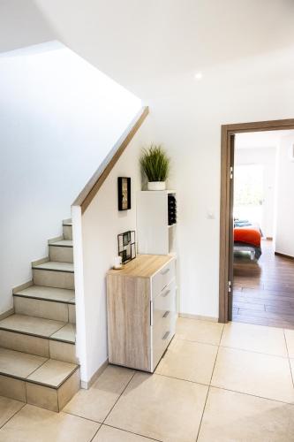 a staircase in a living room with a stair case at villa boileau in Sérignan