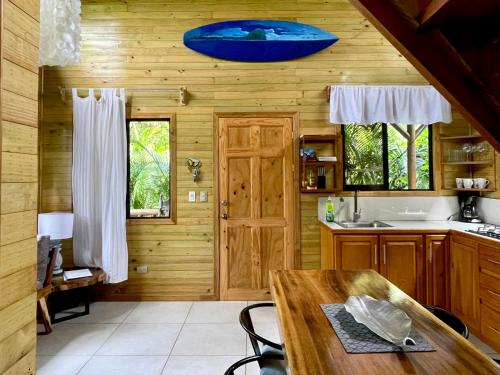 a kitchen with wooden walls and a wooden table at Finca Los Mangos in Manuel Antonio