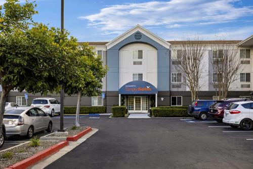 a parking lot in front of a building with cars parked at Sonesta Simply Suites Irvine East Foothill in Lake Forest