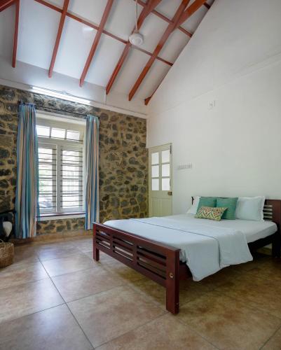 a bedroom with a large bed and a window at Ela Homes in Pala